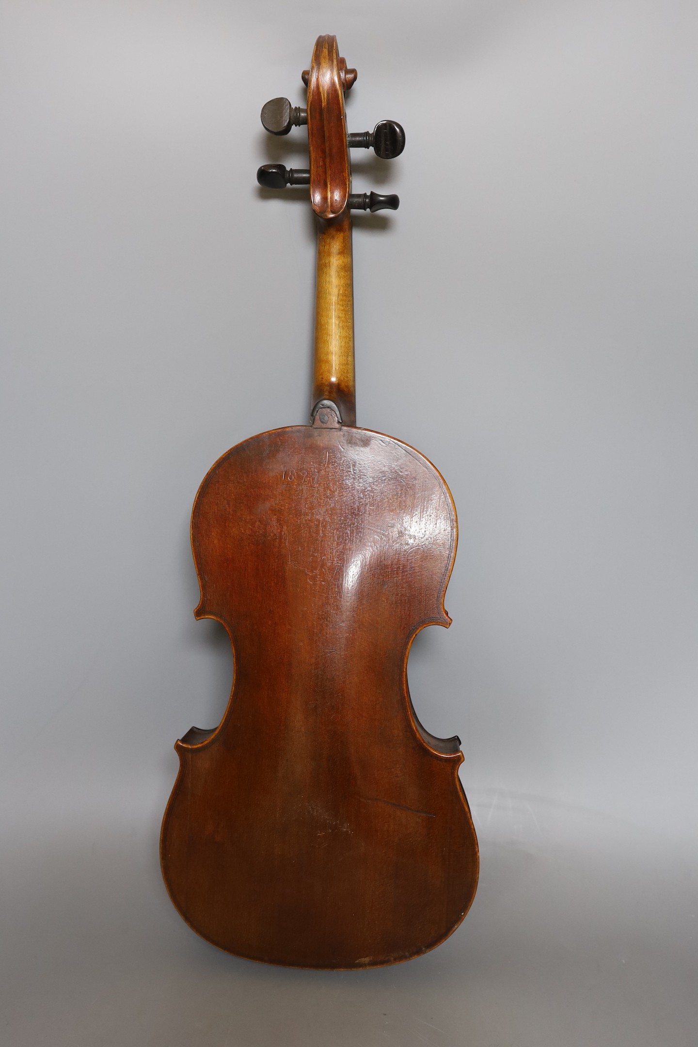 A European violin, circa 19th century, 59 cms long.